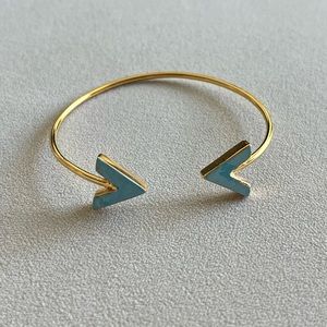 Turquoise color arrow accent on golden cuff bracelet